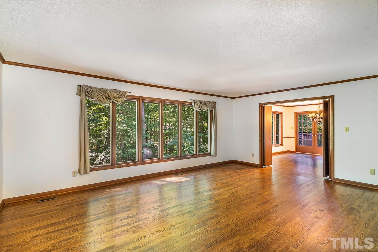 8600 Lawn Court Raleigh, NC 27613 - Photo 9 of 31 a view of an empty room with wooden floor and a window