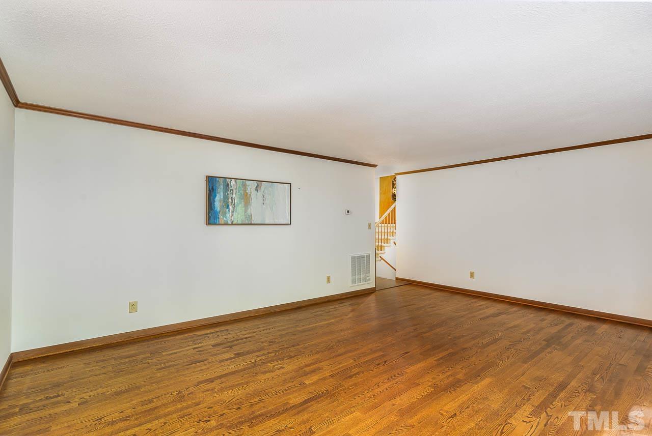 8600 Lawn Court Raleigh, NC 27613 - Photo 10 of 31 an empty room with wooden floor and windows