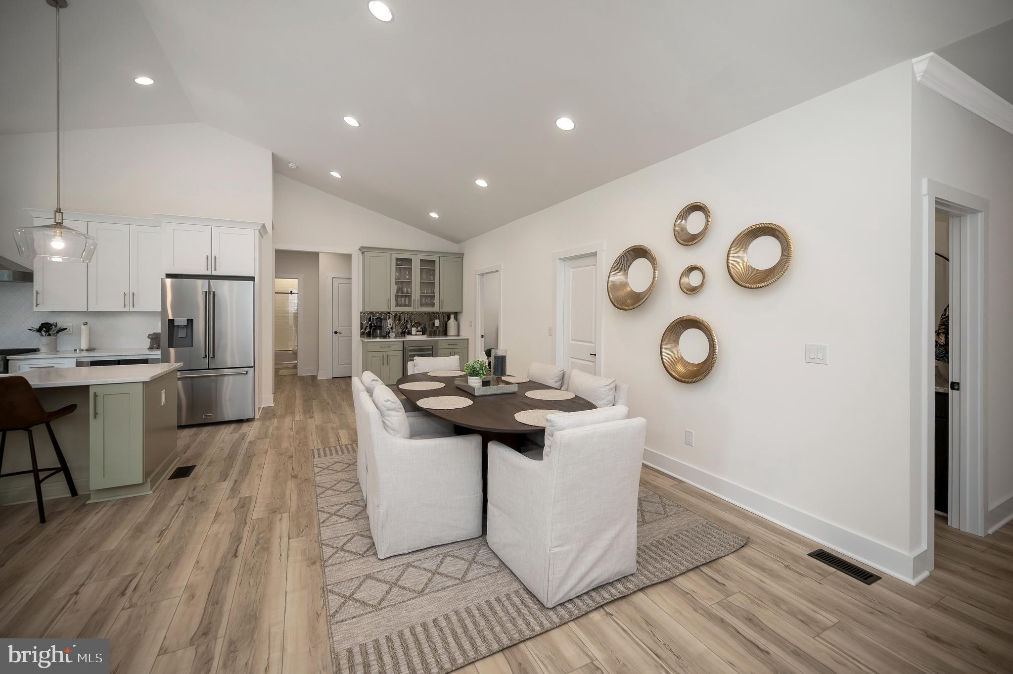 0 Piney Mountain Road Warrenton, VA 20186 - Photo 14 of 33 a kitchen with stainless steel appliances kitchen island granite countertop a refrigerator a stove a sink and a dining table with wooden floor
