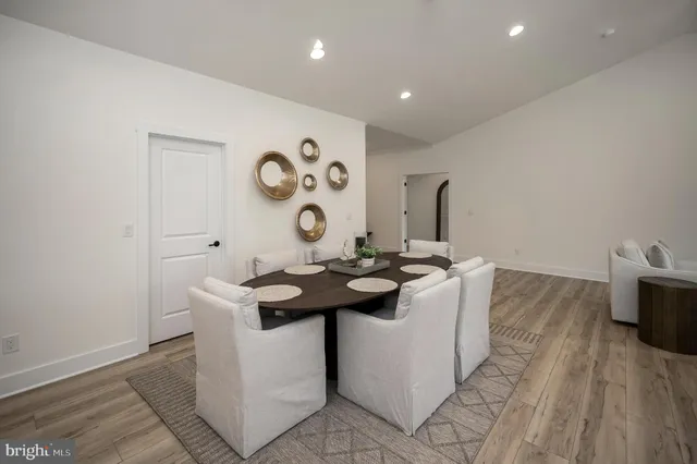 a living room with a sink and a stove with wooden floor