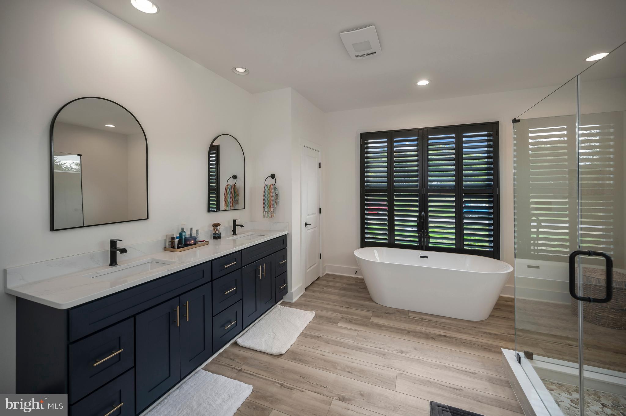 0 Piney Mountain Road Warrenton, VA 20186 - Photo 20 of 33 a spacious bathroom with a double vanity sink a large mirror and bathtub