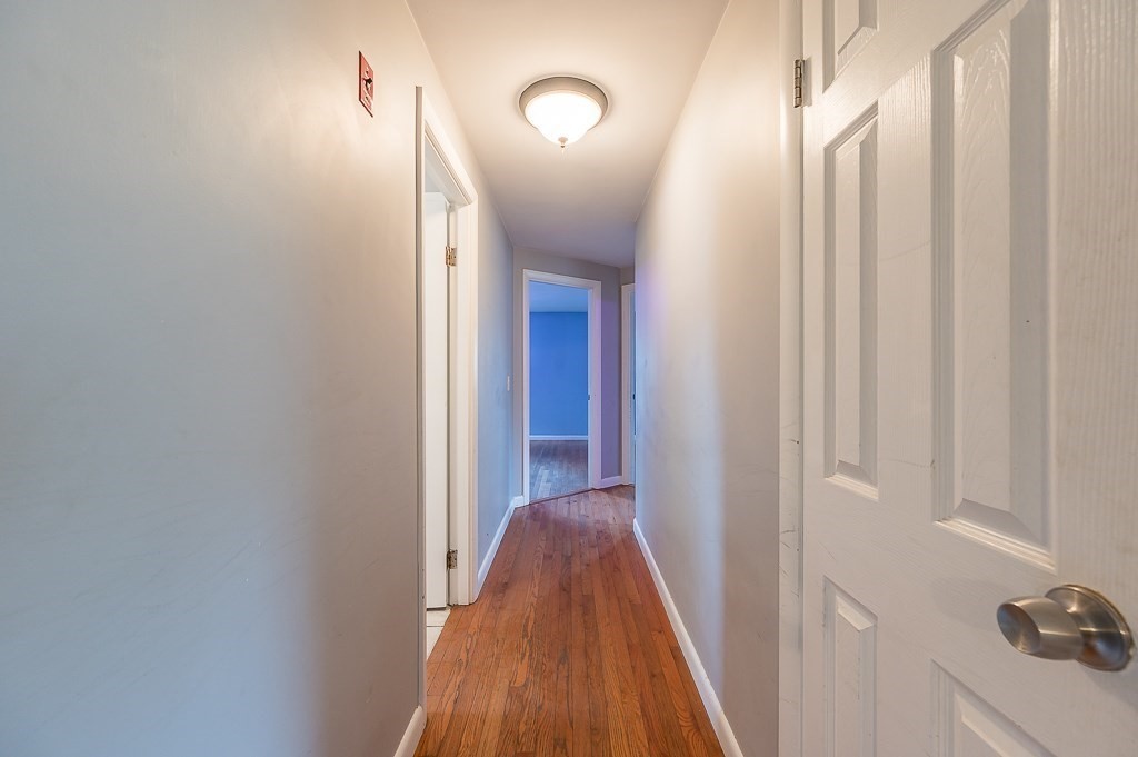 3 Sears Avenue Webster, MA 01570 - Photo 17 of 27 a view of a hallway with a hardwood floor
