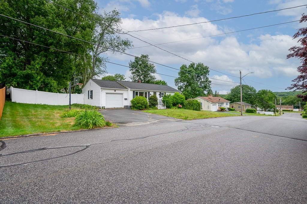 3 Sears Avenue Webster, MA 01570 - Photo 26 of 27 a house with a yard and a car park in front of it