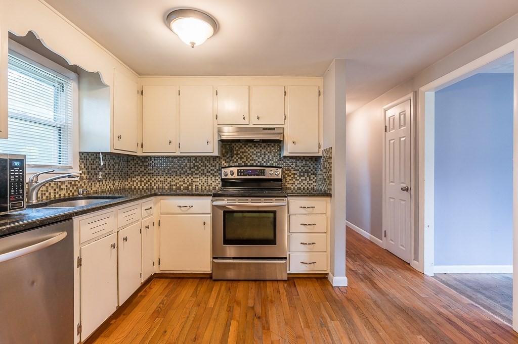 3 Sears Avenue Webster, MA 01570 - Photo 4 of 27 a kitchen with granite countertop white cabinets and white appliances