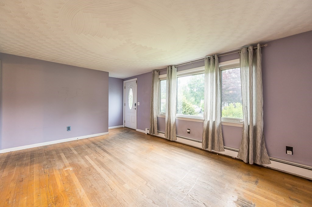 3 Sears Avenue Webster, MA 01570 - Photo 10 of 27 a view of an empty room with wooden floor and a window
