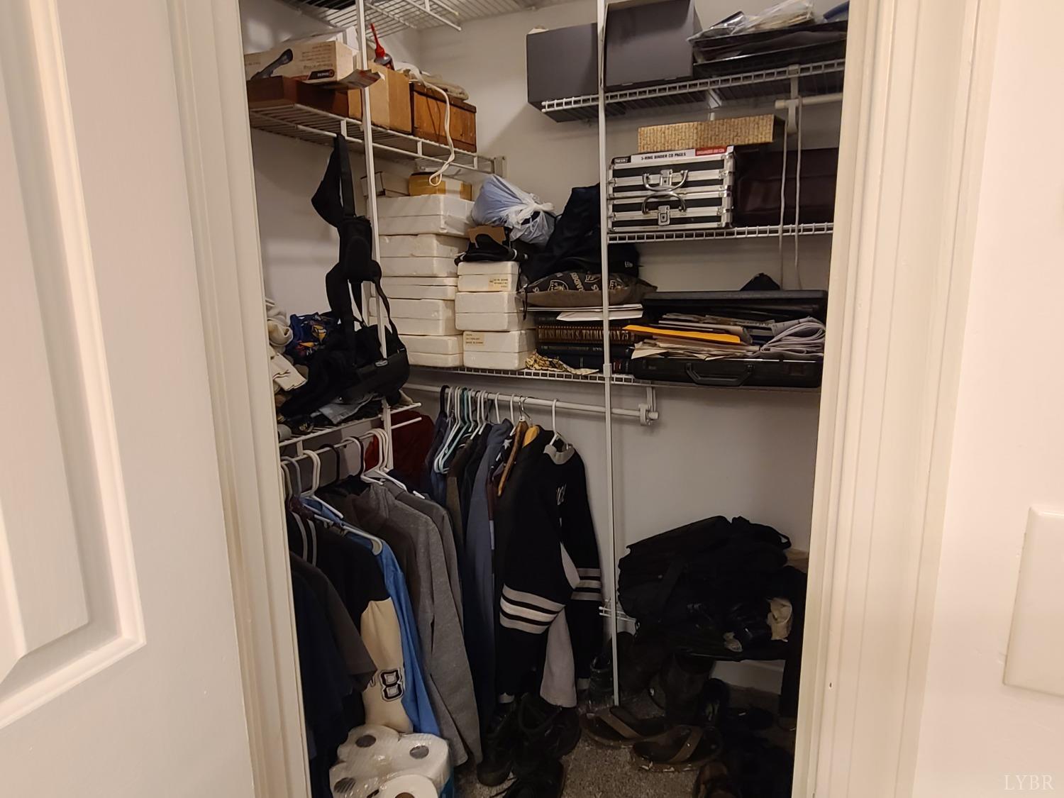 1641 Roark Mill Road Hurt, VA 24563 - Photo 18 of 52 a view of walk in closet with clothes and shoes
