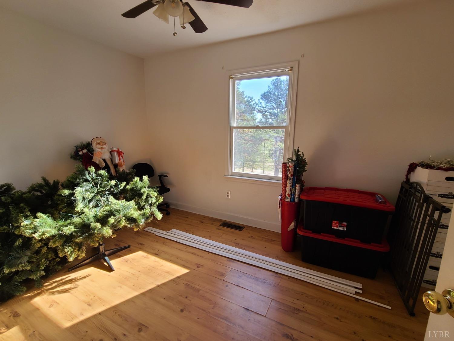 1641 Roark Mill Road Hurt, VA 24563 - Photo 19 of 52 a living room with wooden floor furniture and a potted plant