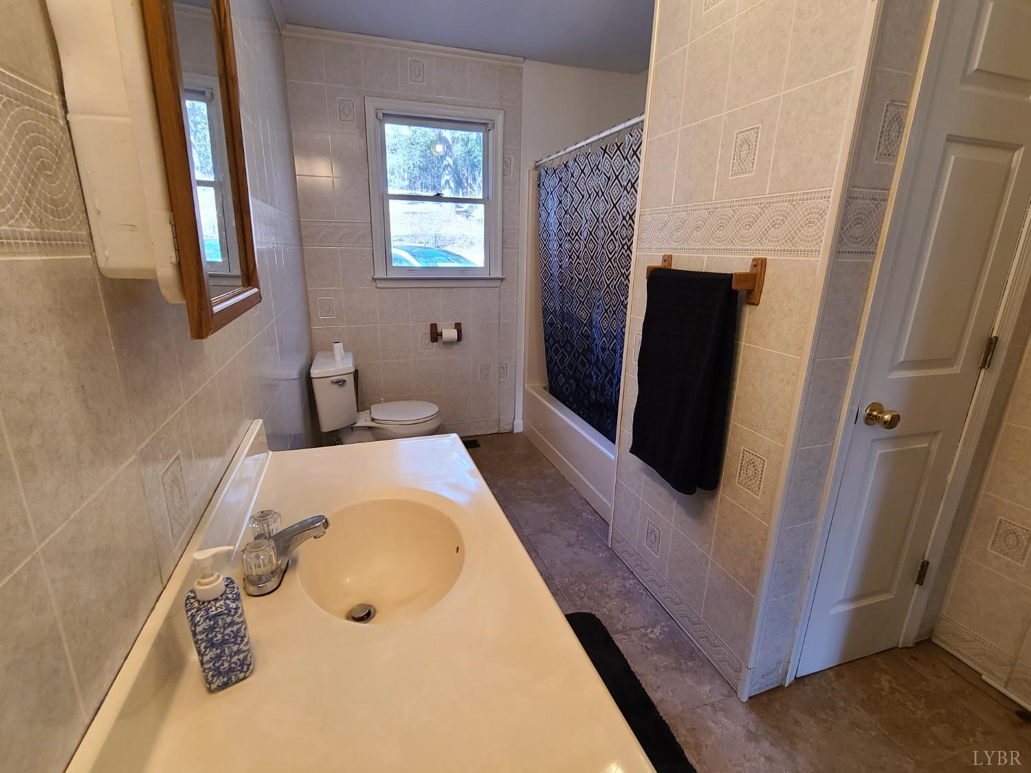 1641 Roark Mill Road Hurt, VA 24563 - Photo 22 of 52 a bathroom with a tub sink and mirror