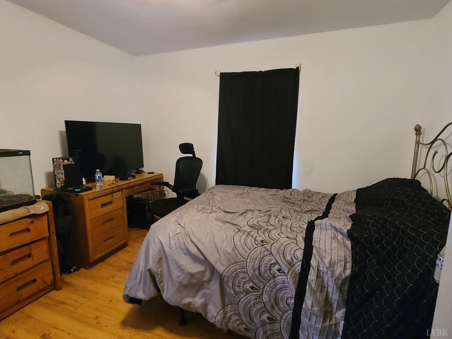 1641 Roark Mill Road Hurt, VA 24563 - Photo 24 of 52 a bedroom with a bed and a flat tv screen on dresser