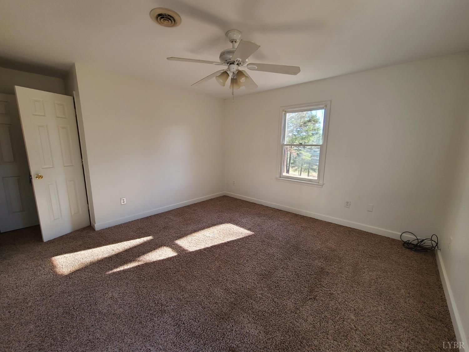 1641 Roark Mill Road Hurt, VA 24563 - Photo 34 of 52 an empty room with a window and a fan