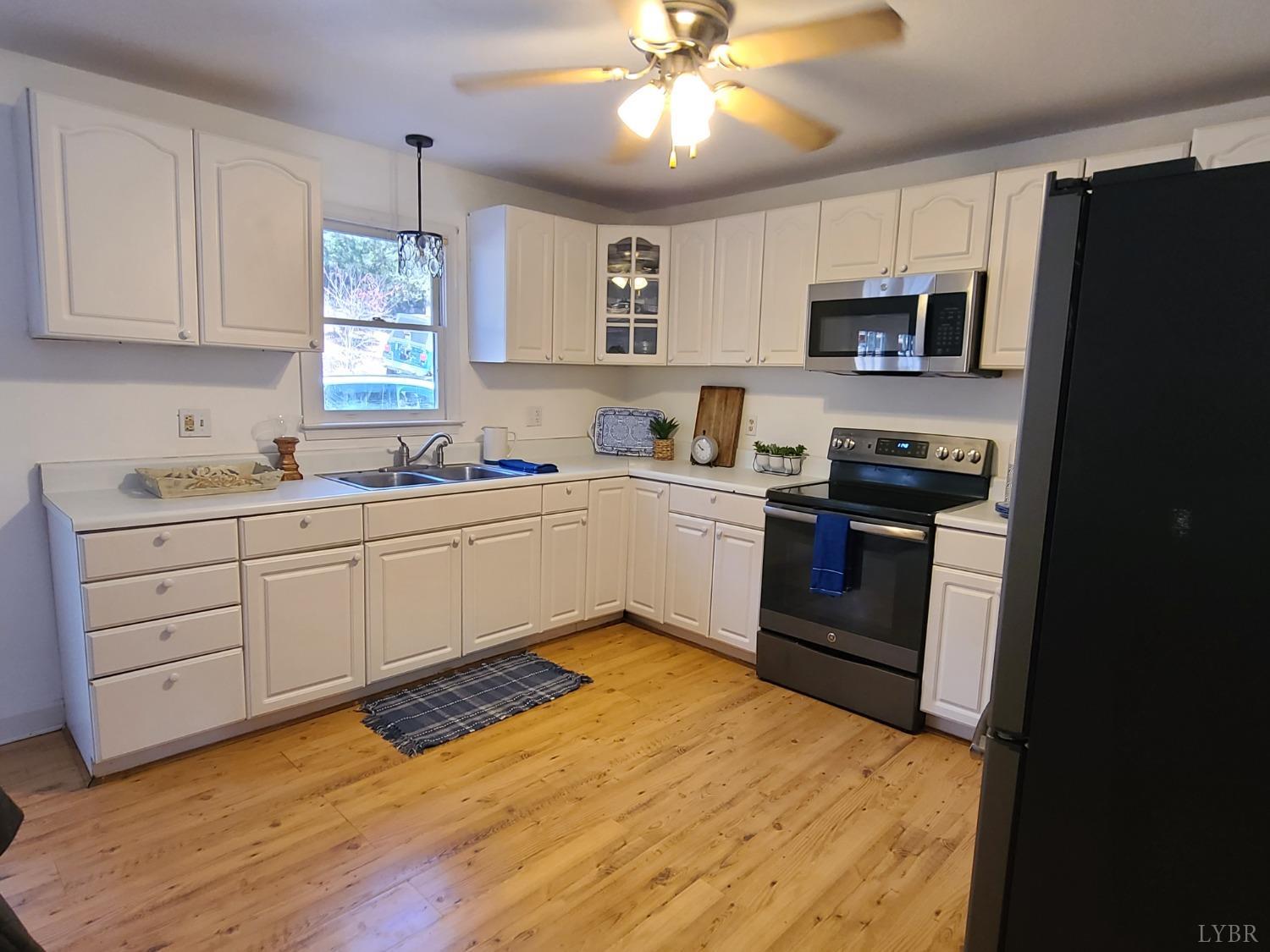 1641 Roark Mill Road Hurt, VA 24563 - Photo 5 of 52 a kitchen with stainless steel appliances granite countertop a sink a stove a refrigerator with grey cabinets