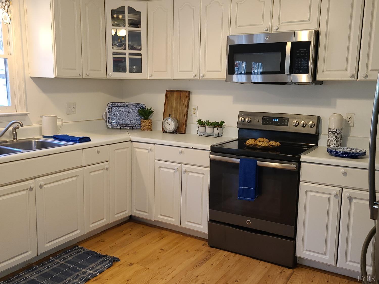 1641 Roark Mill Road Hurt, VA 24563 - Photo 7 of 52 a kitchen with stainless steel appliances granite countertop a sink and a stove