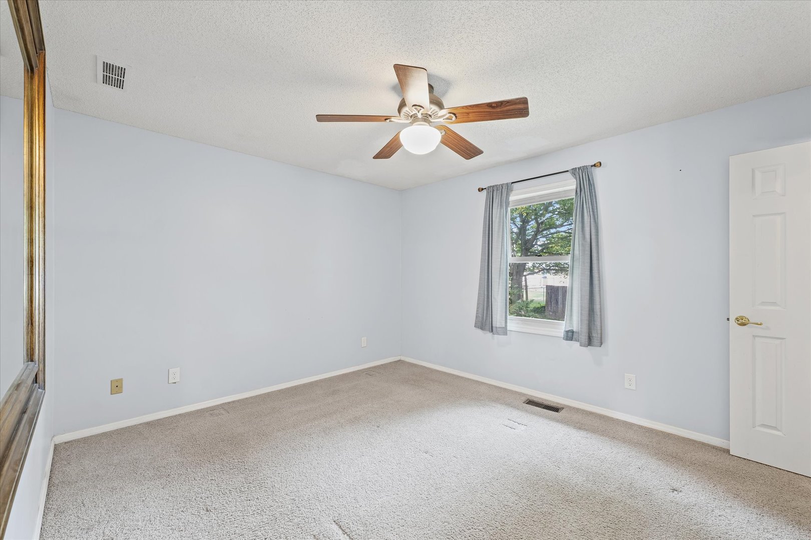 502 Ridge Road Philo, IL 61864 - Photo 13 of 28 an empty room with a window and a ceiling fan