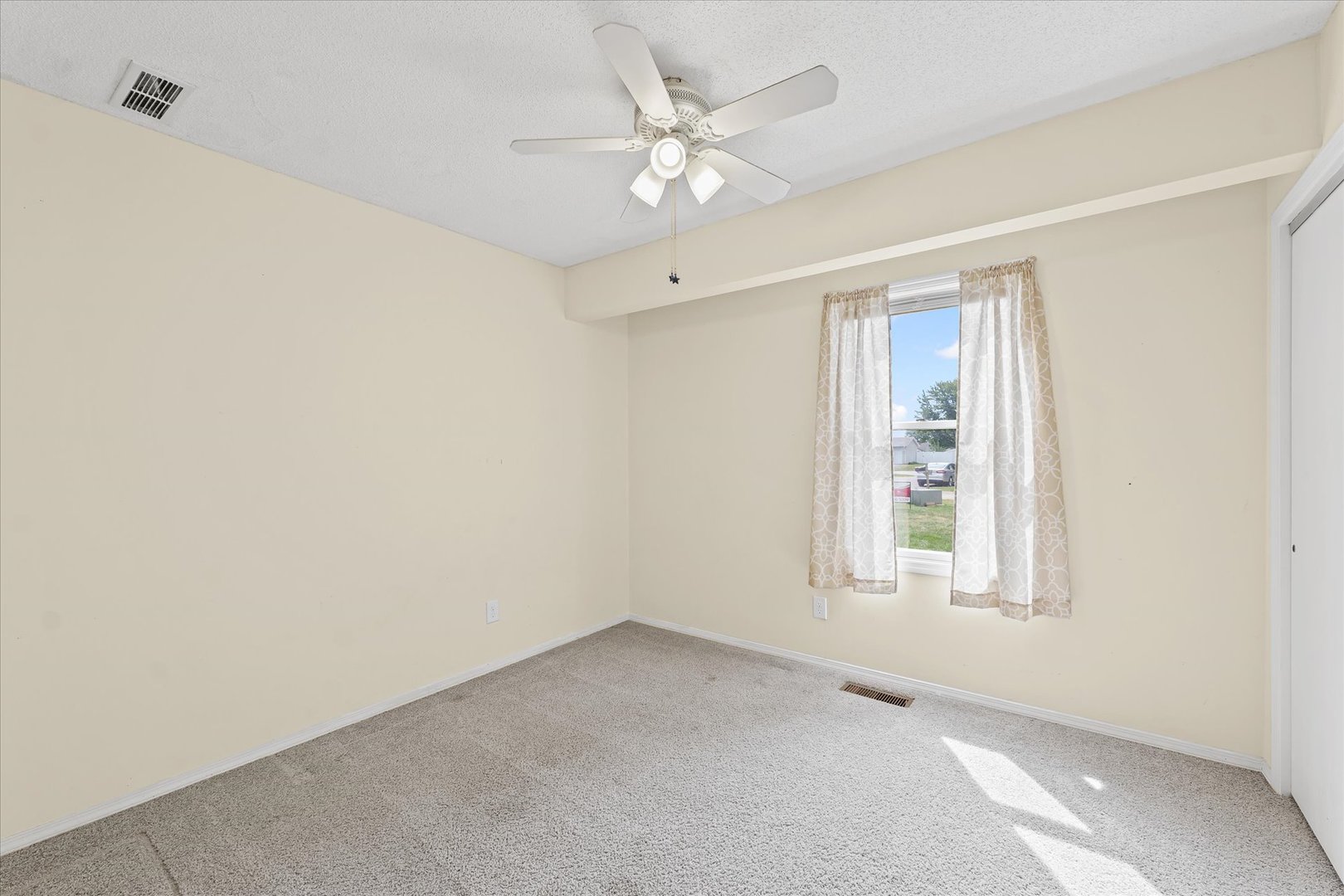 502 Ridge Road Philo, IL 61864 - Photo 18 of 28 an empty room with windows and fan
