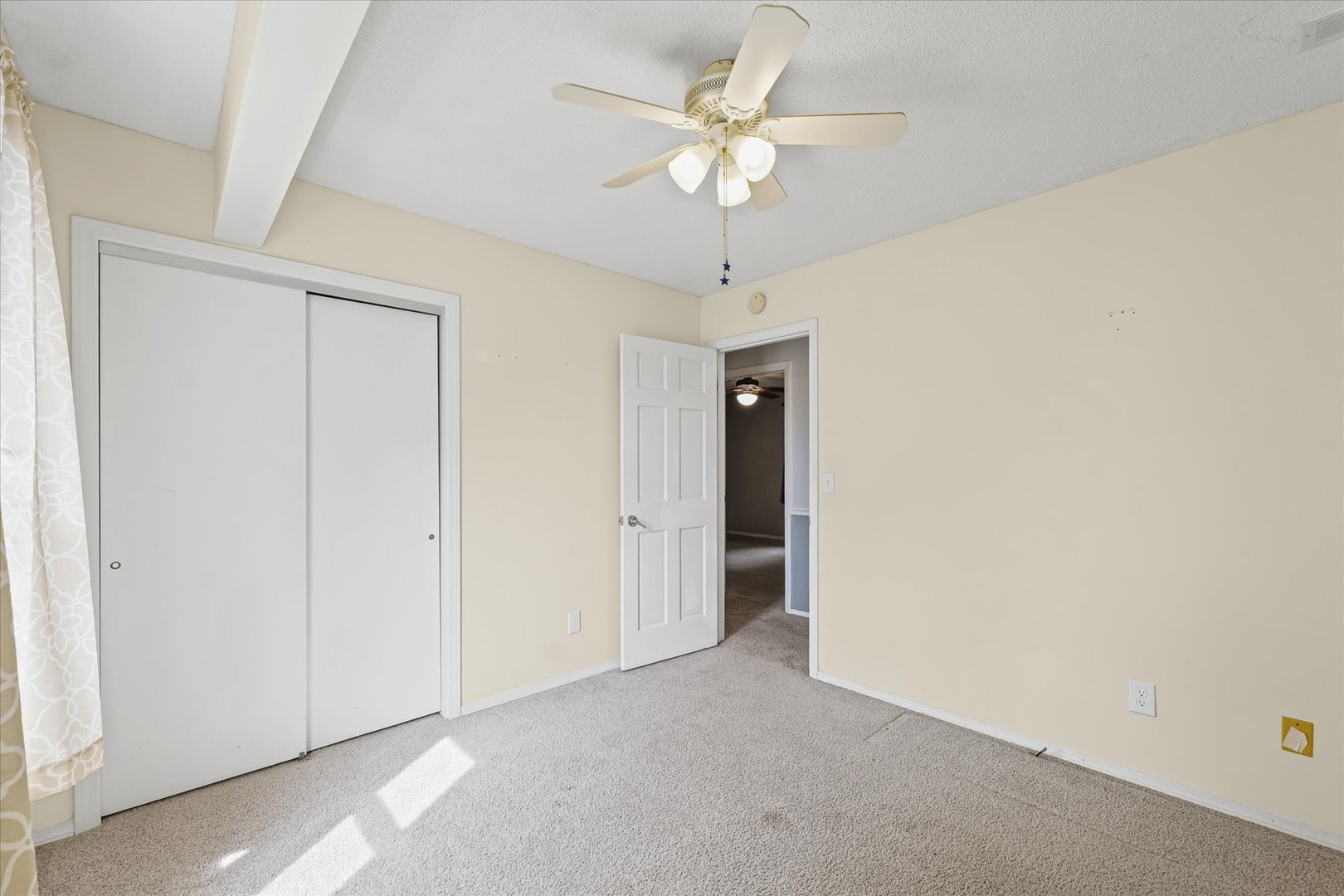 502 Ridge Road Philo, IL 61864 - Photo 19 of 28 an empty room with a chandelier fan and a ceiling fan