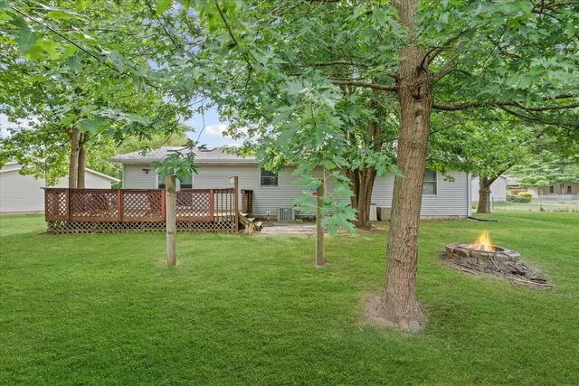 a view of a house with backyard and wooden fence