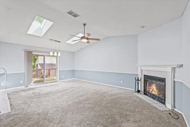 a view of an empty room with a fireplace