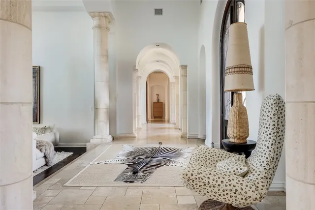 a living room with furniture large window and wooden floor