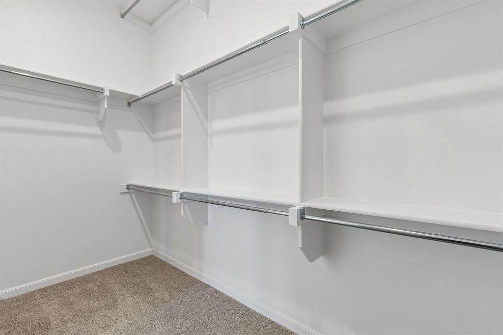15852 Amber Street Frisco, TX 75033 - Photo 11 of 19 Featuring 3rd row seasonal hanging and tons of space, your dream owner's closet awaits!