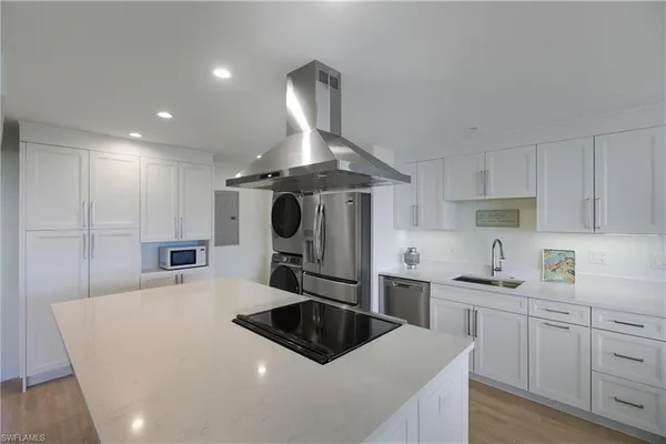 a kitchen with a sink stove and refrigerator