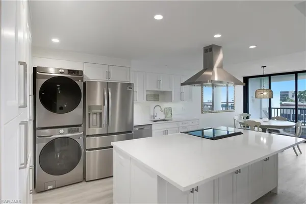 a kitchen with a sink a stove and refrigerator