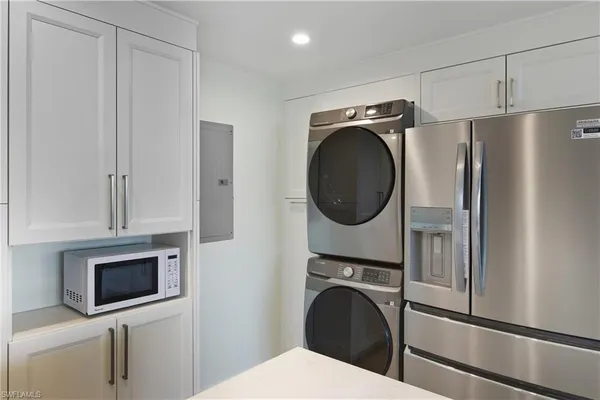 a kitchen with kitchen island a stove a sink a oven and wooden cabinets