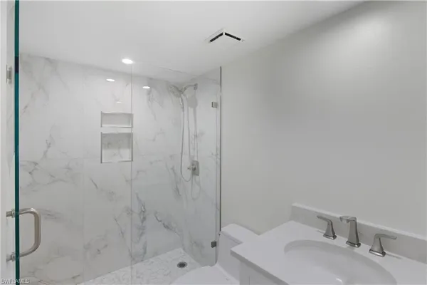 a spacious bedroom with a bed and a couch