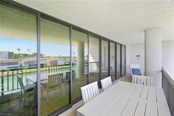 a view of a balcony with wooden floor and seating space