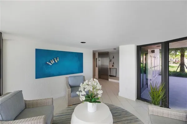 a lobby with furniture and a potted plant
