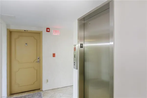 a room with a elevator and wooden door