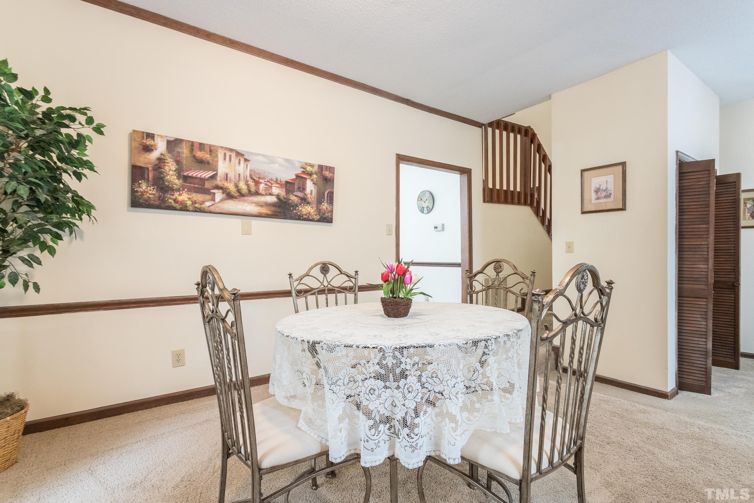 8413 Running Cedar Trail Raleigh, NC 27615 - Photo 13 of 28 a view of a dining room with furniture and wooden floor