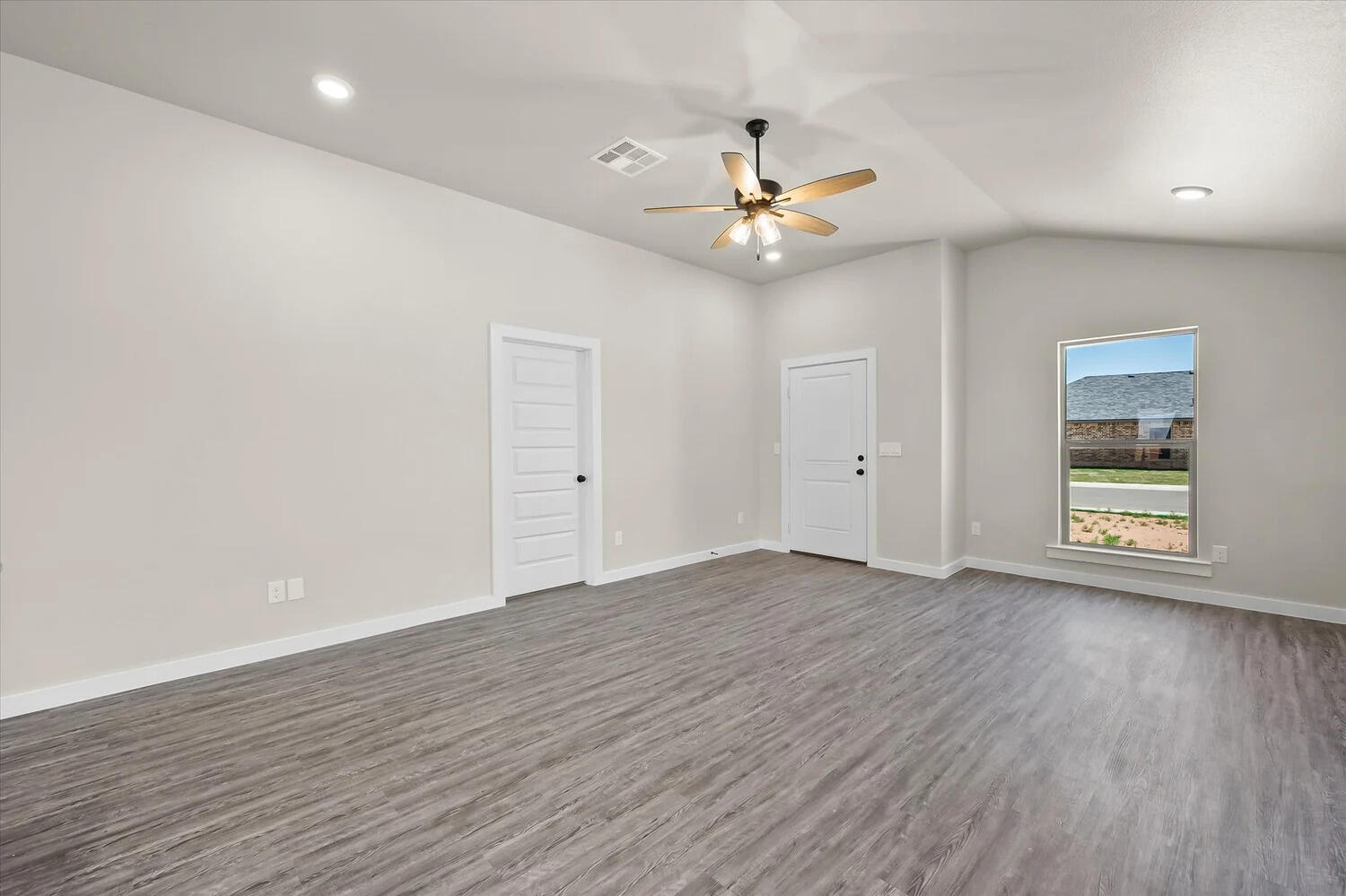 7446 29th Street Lubbock, TX 79407 - Photo 6 of 11 wooden floor in an empty room with a window