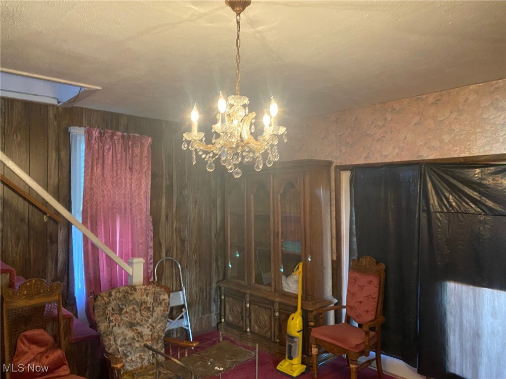 46790 Moore Ridge Road Woodsfield, OH 43793 - Photo 12 of 18 Dining room with wood walls and an inviting chandelier