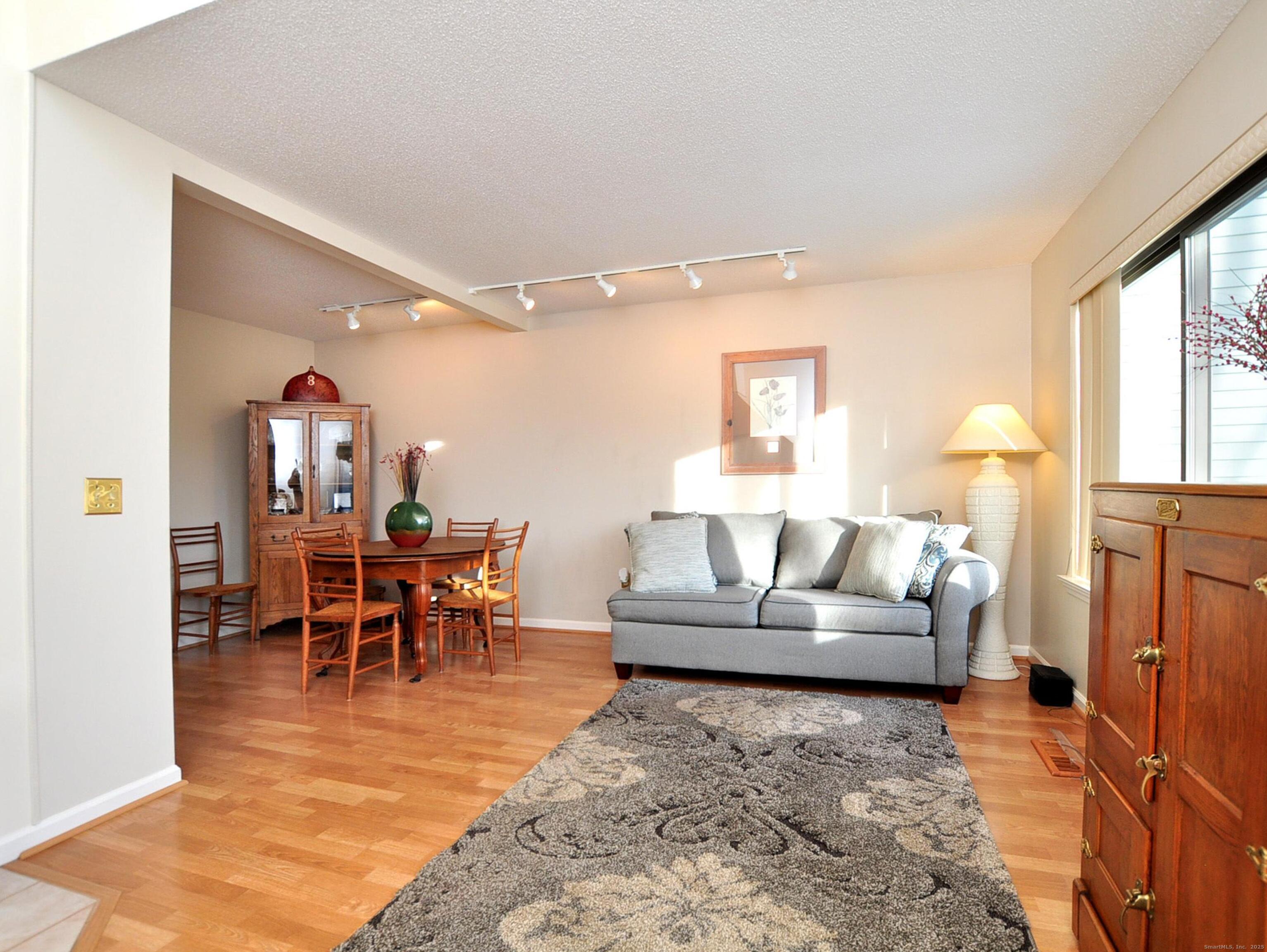 81 Silo Way, Unit 81 Bloomfield, CT 06002 - Photo 16 of 37 a living room with furniture and a dining table