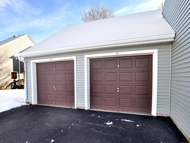 a front view of a house with garden and trees