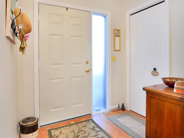 a view of a hallway with front door windows and glass door