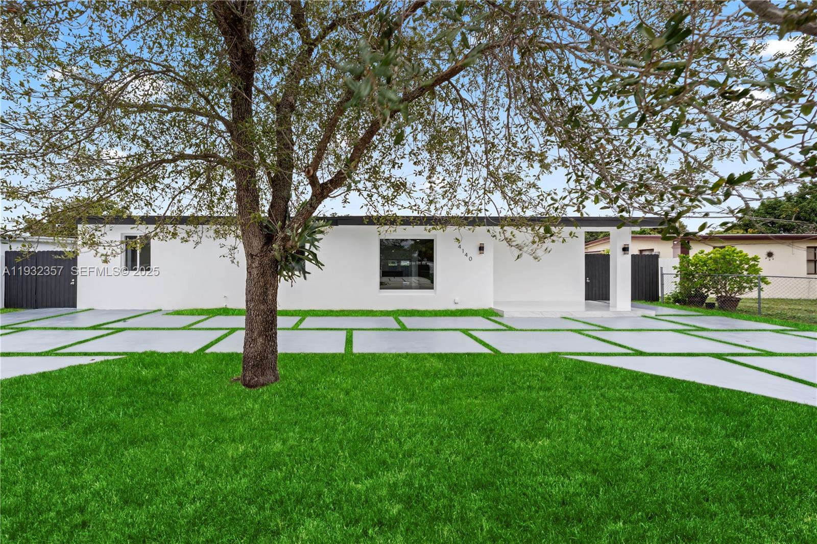 4140 Southwest 108th Avenue Miami, FL 33165 - Photo 2 of 51 a front view of a house with a yard and garage