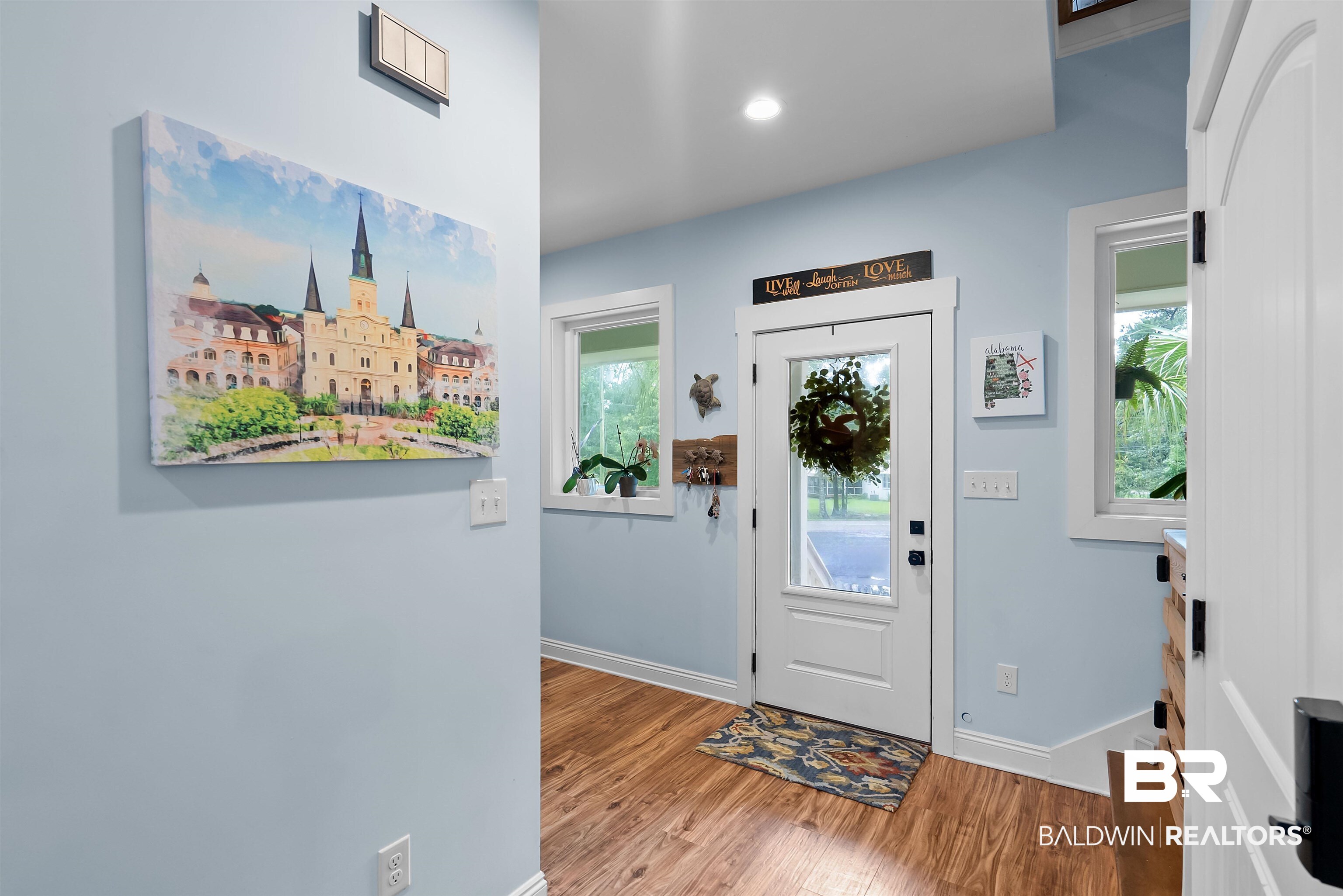 7266 Franklin Road Foley, AL 36535 - Photo 21 of 64 Entryway featuring wood-finish flooring, light blue wall paint, a white full-light entry door, and two adjacent windows with white trim