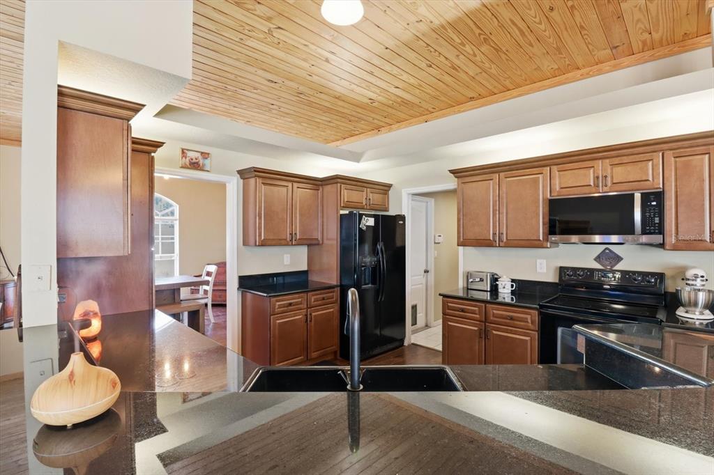 3030 South Bay Berry Point Inverness, FL 34450 - Photo 15 of 45 a kitchen with a refrigerator and a stove