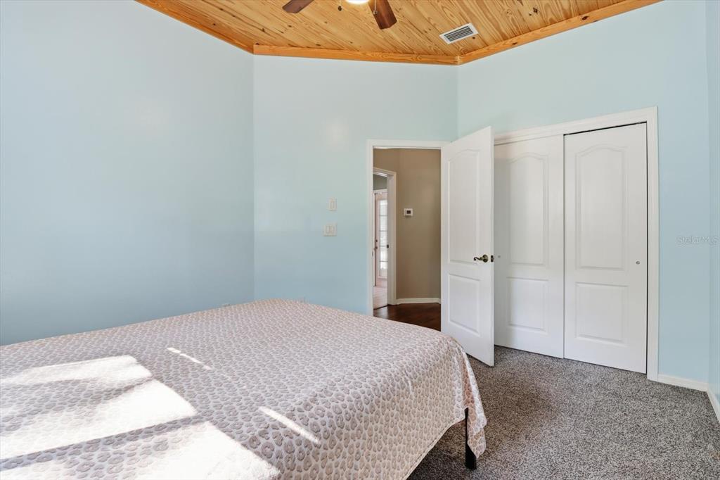 3030 South Bay Berry Point Inverness, FL 34450 - Photo 19 of 45 a bedroom with a bed and a night stand