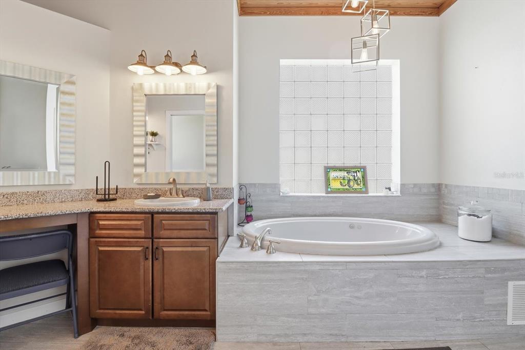3030 South Bay Berry Point Inverness, FL 34450 - Photo 25 of 45 a spacious bathroom with sinks mirror and a bathtub