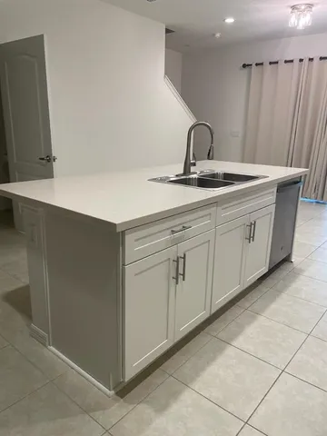 a kitchen with a sink and cabinets