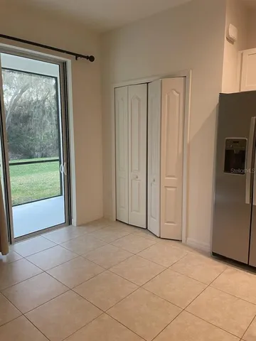 a view of a kitchen with a refrigerator cabinets and a refrigerator