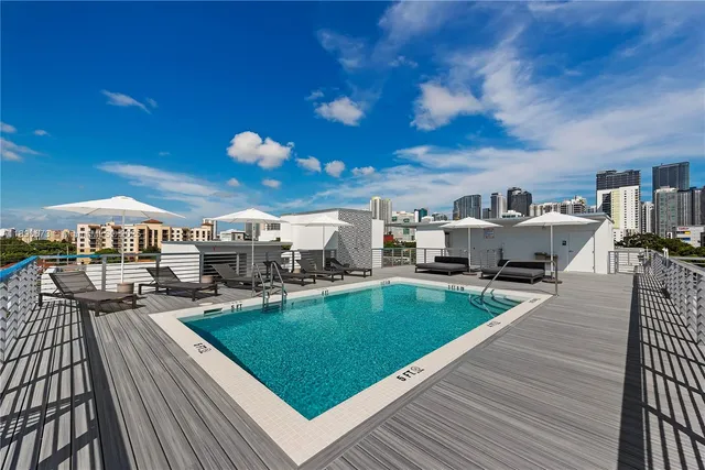 a view of a patio with dining table and chairs with wooden floor and fence