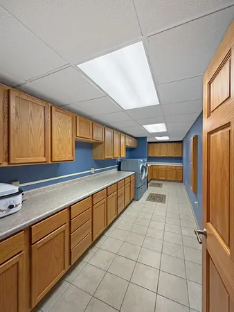 a spacious bedroom with a bed and a dresser in it