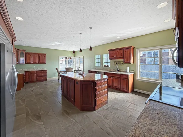 a view of a dining room with furniture and a kitchen