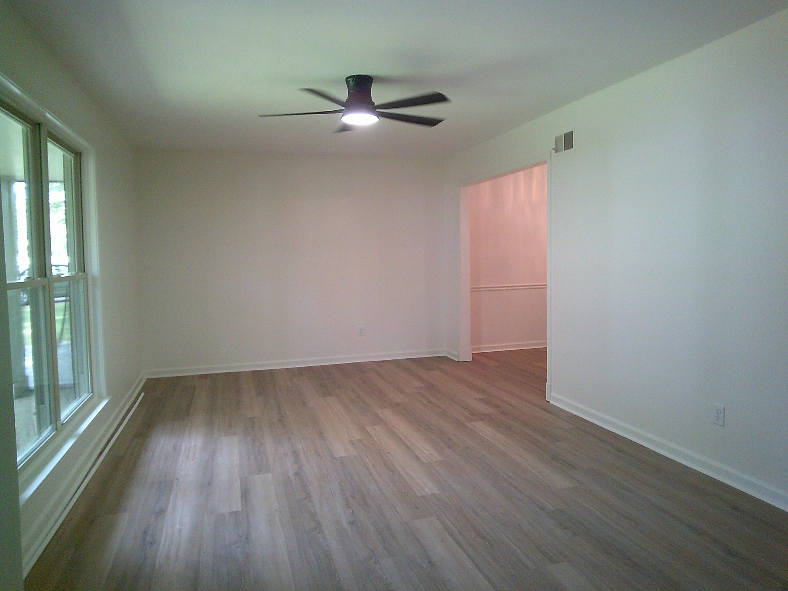235 Morton Road Collierville, TN 38017 - Photo 16 of 18 an empty room with wooden floor fan and windows