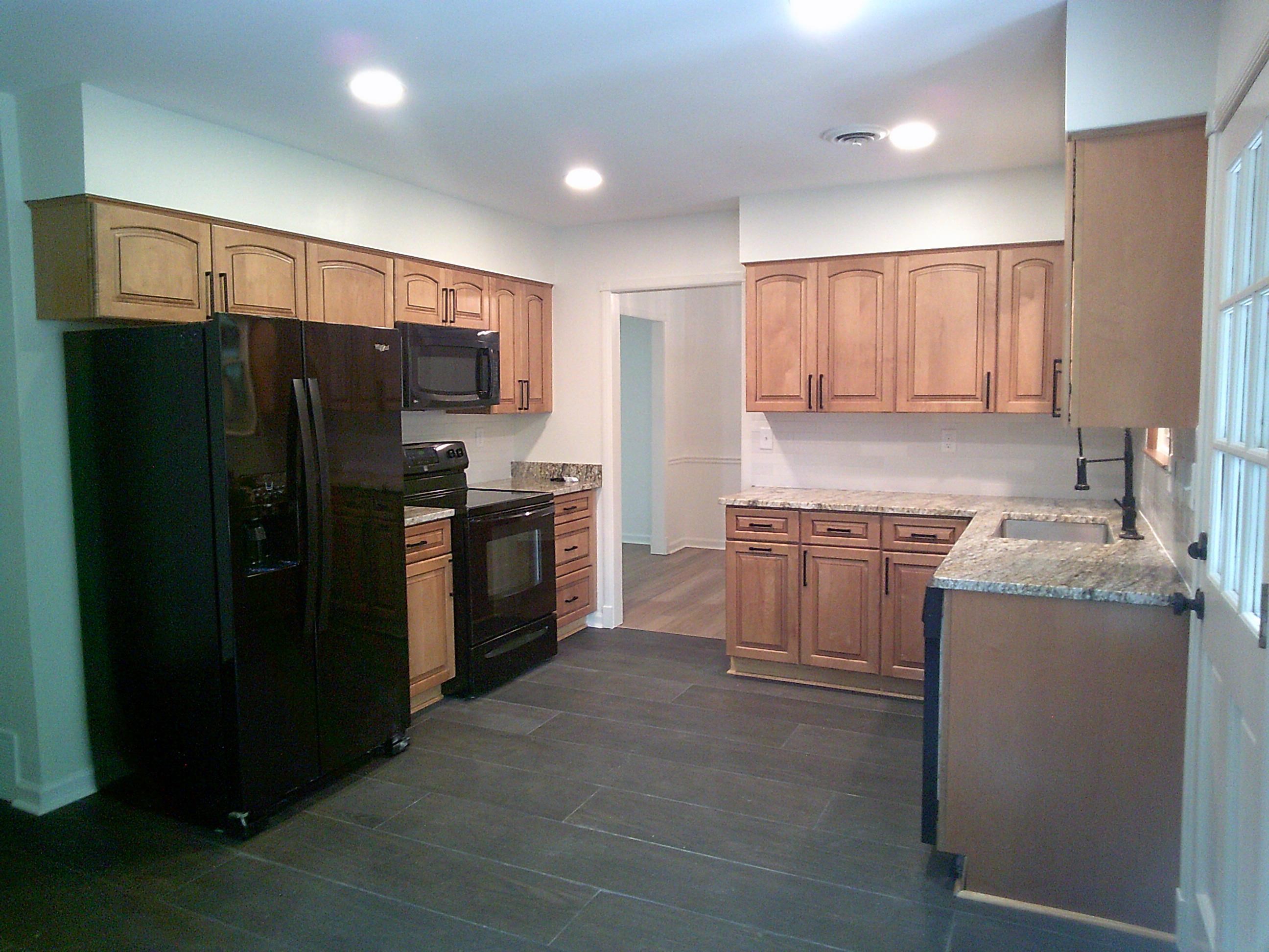 235 Morton Road Collierville, TN 38017 - Photo 3 of 18 a kitchen with granite countertop a refrigerator and a stove top oven