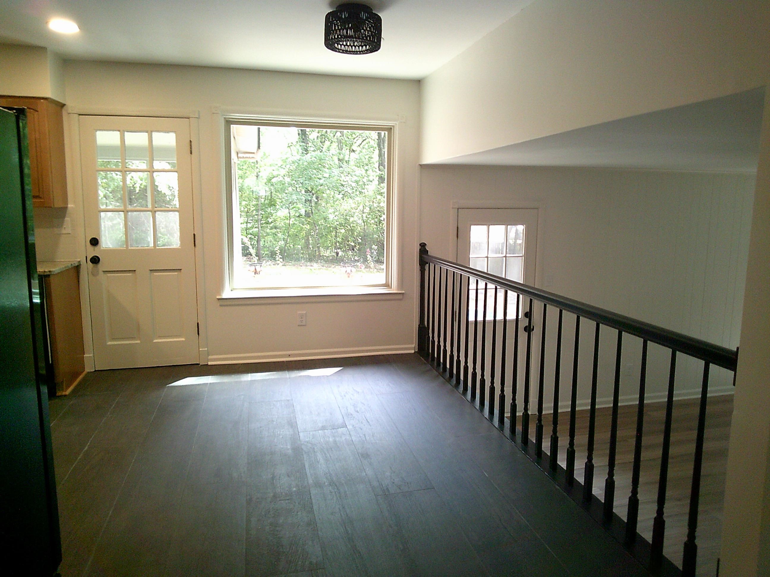 235 Morton Road Collierville, TN 38017 - Photo 6 of 18 a view of an empty room with wooden floor and a window
