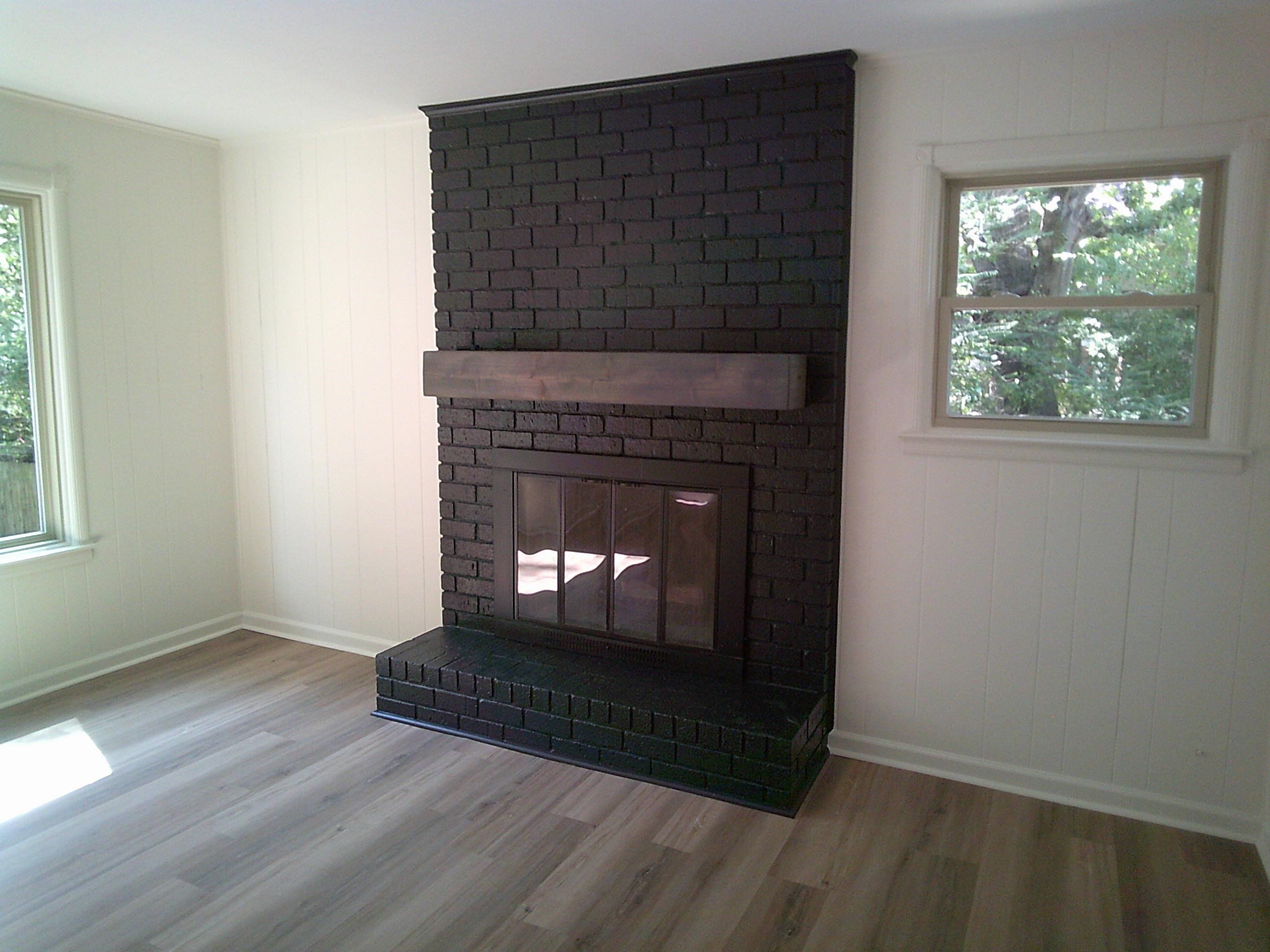 235 Morton Road Collierville, TN 38017 - Photo 8 of 18 an empty room with wooden floor fireplace and windows